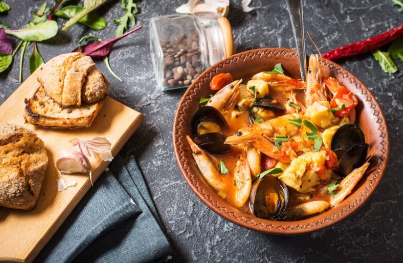 A vibrant bowl of Cioppino Seafood Stew, brimming with fresh seafood and rich tomato broth