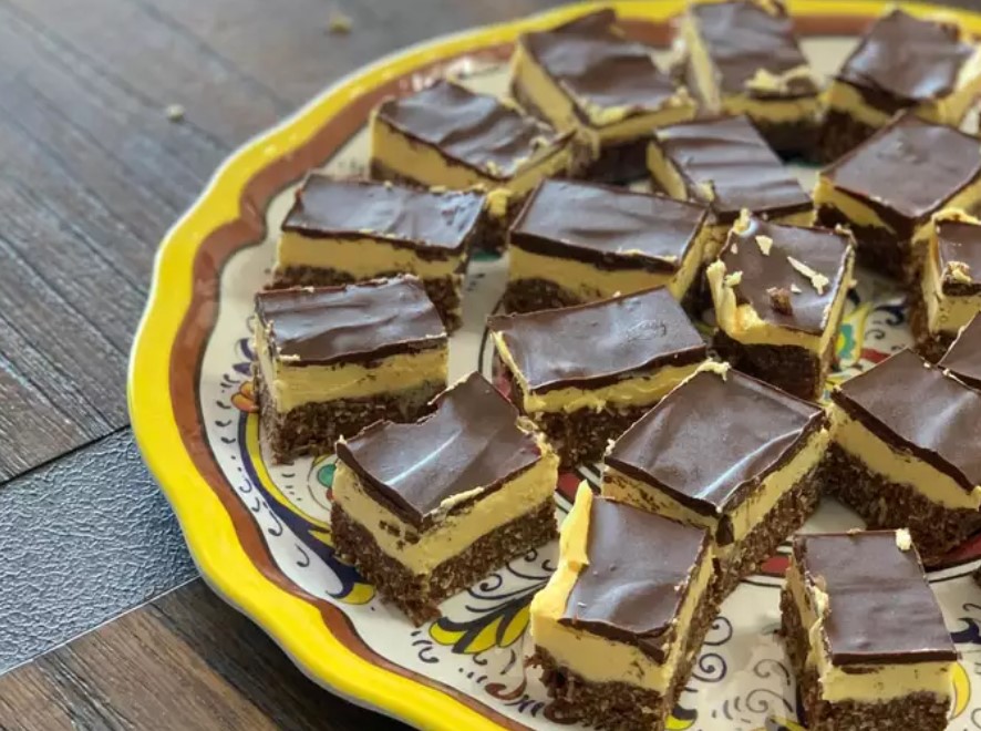 "A stack of delicious Nanaimo Bars with visible layers, showcasing the classic Canadian dessert.