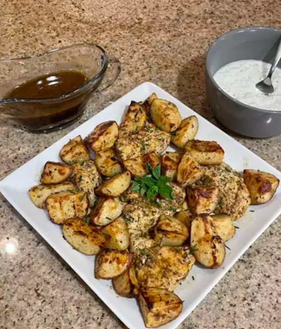 Plate of Greek Lemon Chicken and Roasted Potatoes with Fresh Herbs