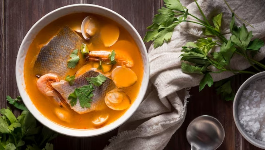 A bowl of creamy fish chowder garnished with fresh herbs, indicating a delicious homemade recipe.