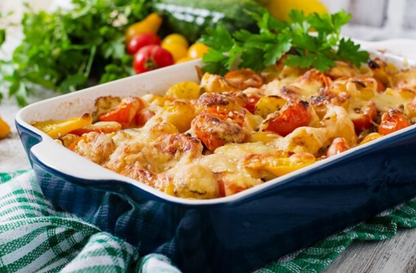 A delicious Tuscan Chicken Pasta Bake served on a rustic table, garnished with fresh herbs, symbolizing authentic Italian home cooking.