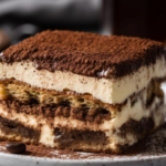 A luscious Peanut Butter Eclair Cake on a serving dish, showcasing its creamy layers and chocolate topping.